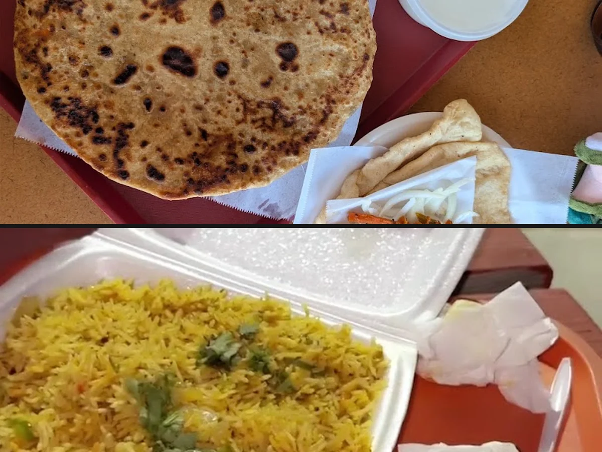 Indian restaurant plates with rice and curry.