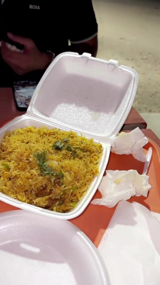 Indian restaurant plates with rice and curry.